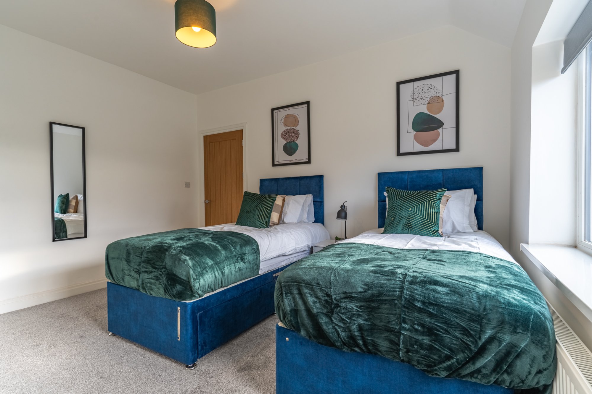 Twin bedroom with teal bedding